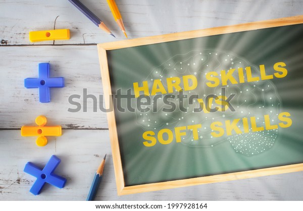 Hard skill and soft skills with brain drawing on\
chalkboard with mathematics symbol and colored pencil on wooden\
desk. Business development success concept and career challenge\
motivation idea 