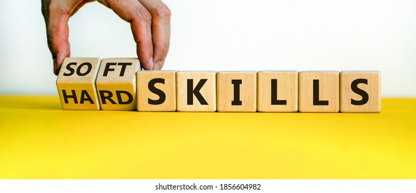 Hard skills versus soft skills. Hand flips cubes and changes the expression 'hard skills' to 'soft skills' or vice versa. Beautiful yellow table, white background. Business concept. Copy space. - Shutterstock ID 1856604982