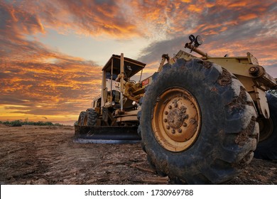 Hard truck grader tractor working at  construction site and sky background