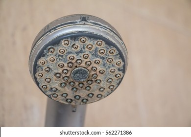 Hard water deposit and rust on shower tap