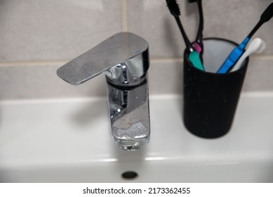 Hard Water Residue And Toothpaste Dirt On The Bathroom Tap