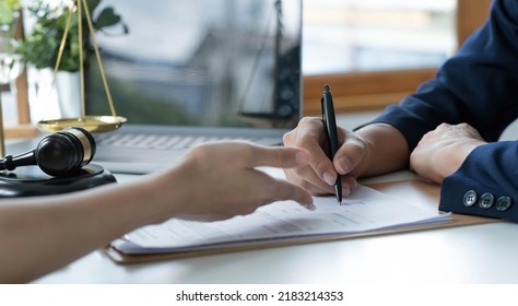 The hard work of an asian lawyer in a lawyer's office. Counseling and giving advice and prosecutions about the invasion of space between private and government officials to find a fair settlement. - Shutterstock ID 2183214353