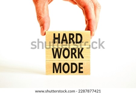 Hard work mode symbol. Concept words Hard work mode on wooden block on a beautiful white table white background. Businessman hand. Business and Hard work mode concept. Copy space.