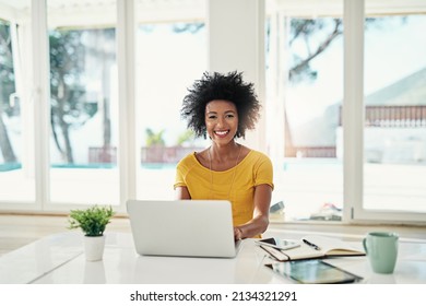 Hard Work Pays Off. Cropped Portrait Of An Attractive Young Woman Working On Her Laptop At Home.