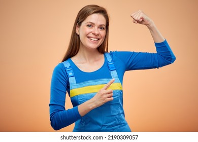 Hard Worker Woman In Overalls Flexing Arm. Woman Power Concept. Isolated Female Portrait.