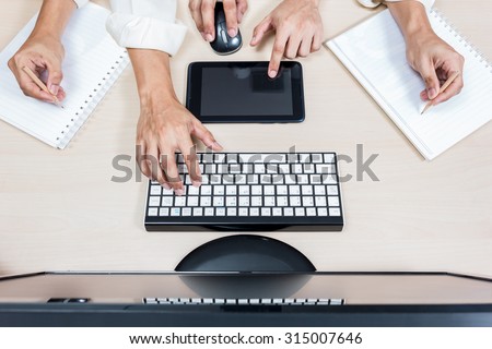 hard working asian businessman, male employee hands with computer on workspace desk in office