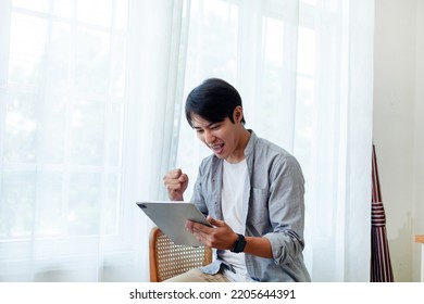 Hard Working Asian Man Happily Using Laptop At Work. Asian Businessmen Use Laptop Computers To Work With Customers. Business Lifestyle Concept.
Asian Businessman Using Laptop To Work By The Window