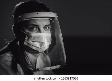 Hard Working Female Doctor, Heath Care Worker With Face Shield And Mask In Black And White