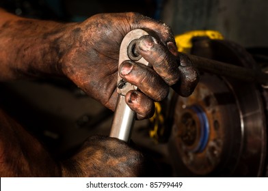 Hard working man with hands full of oil