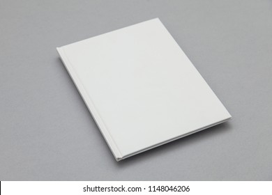 Hardback book cover mockup. White book on a grey background