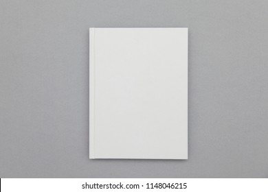 Hardback book cover mockup. White book on a grey background