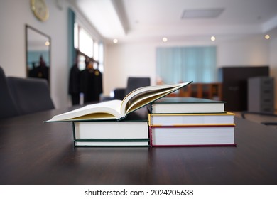 Hardcover Law Books Stack On Dark Brown Wooden Table In Blur Office Room Background , Law Office , Pile Of Books