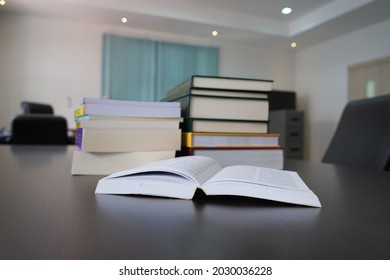 Hardcover Law Books Stack And Open Book On Wooden Table In Blur Office Room For Design Business Or Education  Background, Pile Of Books