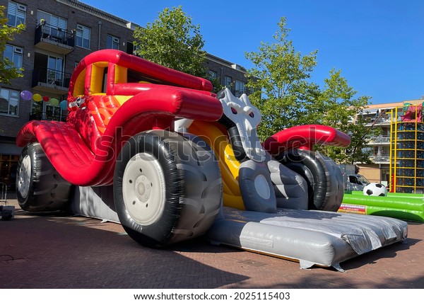 Hardenberg, the Netherlands - August 14 2021 - An\
event agency is building bouncing objects for children in the\
middle of the city center. This Monstertruck bouncy castle is 6\
meters high.
