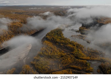 hard-to-reach areas. Taiga view from the helicopter. Autumn forest aerial photo. far east taiga view from helicopter. Winding forest river top view. wild siberian landscape. Hard-to-reach places.