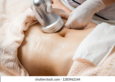 Hardware cosmetology. Body care. Spa treatment. Ultrasound cavitation body contouring treatment. Woman getting anti-cellulite and anti-fat therapy in beauty salon.  