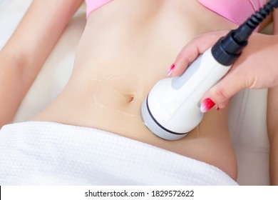 Hardware cosmetology. Body care. Spa treatment. Ultrasonic cavitation body contouring treatment. A woman receives anti-cellulite and anti-fat therapy in a beauty salon. - Shutterstock ID 1829572622