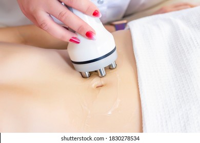 Hardware cosmetology. Body care. Spa treatment. Ultrasonic cavitation body contouring treatment. A woman receives anti-cellulite and anti-fat therapy in a beauty salon.
