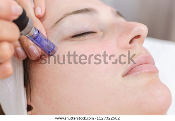 Hardware cosmetology, mesotherapy,
treatment of cheek zone, face rejuvenation, close
up