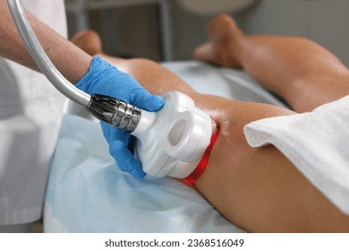 Hardware cosmetology. Radio frequency lifting of skin of legs. Body care. Ultrasonic cavitation procedure for body correction. Anti-cellulite therapy in beauty salon. - Powered by Shutterstock