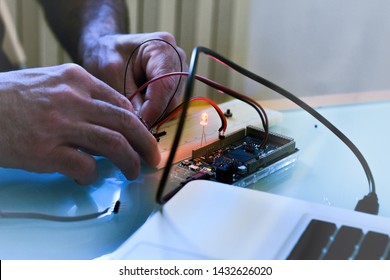 hardware engineer testing a mini motherboard for internet of things and computer  components. concept of industrial IOT profession.