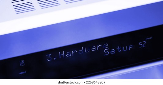Hardware setup text on the LCD display aluminum facade figh-end stereo audio hi-fi receiver - close-up tilt-shift lens used