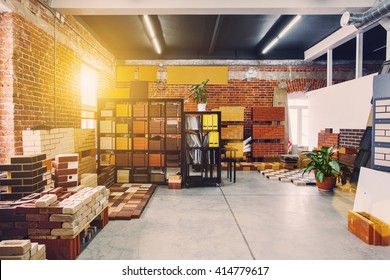 Hardware store office. Samples colored bricks. Brick wall interior. Sunlight from big window
