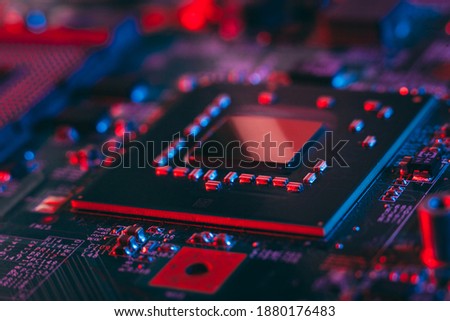 Hardware technology concept in neon light. Motherboard in blue-red light. Computer  component. Dark photo.Neon Colors.GPU processor. CPU