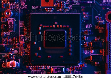 Hardware technology concept in neon light. Motherboard in blue-red light. Computer  component. Dark photo.Neon Colors.GPU processor. CPU
