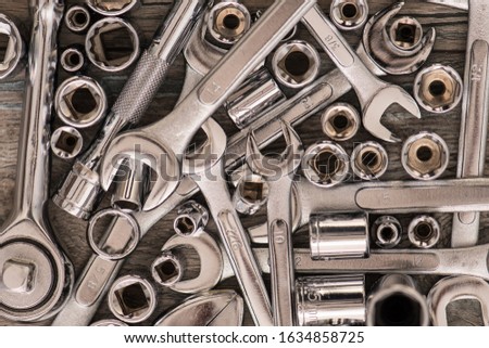 Hardware Tools, adjustable wrench, socket wrench, Sockets on wood background, top view, flat lay. Stainless Steel and Chrome Tools
