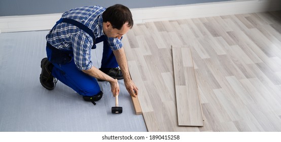 Hardwood Floor Renovation. Construction Worker Doing New Laminate Installation - Shutterstock ID 1890415258