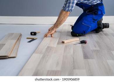 Hardwood Floor Renovation. Construction Worker Doing New Laminate Installation - Shutterstock ID 1905906859