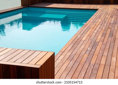 Hardwood ipe pool deck on direct sun heat, summer swimming pool decking design idea - Shutterstock ID 2105154713