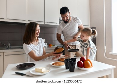 hardworking girl putting , moving pancakes on the plate, close up photo. best helper. close up photo, family tradition - Powered by Shutterstock