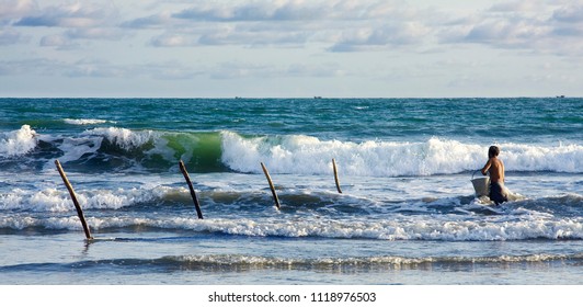 Hardworking man fishing at the ocean shore