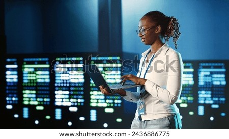 Hardworking IT practitioner strolling through server rows providing processing resources for different workloads. Tech savvy executive monitoring supercomputers tasked with solving complex operations