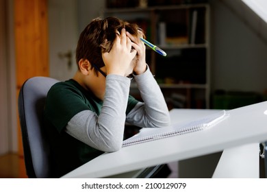 Hard-working Sad School Kid Boy Making Homework During Quarantine Time From Corona Pandemic Disease. Upset Tired Child On Home Schooling In Coronavirus Covid Time, Schools Closed.