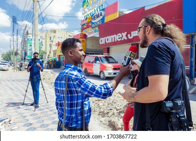 Hargeisa, Somaliland - Nobember 10, 2019: Local Daily News Talikng An Interview From Man Tourist On The Street