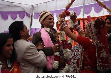 HARIDWAR, INDIA - JANUARY 14: Bride wears a wreath at the groom, which means their betrothal in a traditional Indian wedding, January 14, 2009 in Haridwar, India.