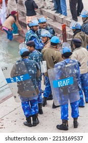 HARIDWAR, UTTARAKHAND, INDIA - JANUARY 12 2010: Members Of The RAF (Rapid Action Force) Watching The Crowd Of Pilgrims At The Ghat, The RAF Deals With Riot And Crowd Control Situations