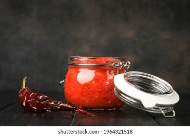 Harissa In A Jar On A Rustic Background With Copy Space.