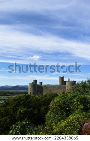 Harlech Castle, Wales. Landscape view of a historic UNESCO monument.   Beautiful Welsh world heritage site.  Fortification of Edward 1 of England.  Blue sky and copy space. Stock photo © 