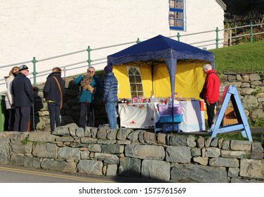 Harlech, Gwynedd, Wales, UK. November 30, 2019. November 30, 2019.  People Standing At A Colourful Stall At A Winter Craft Fair In The Centre Of The Village.