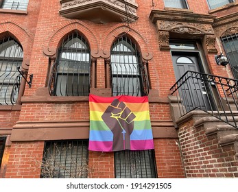 Harlem, NY, USA - February 10, 2021: A BLM Pride Flag Hangs Outside Of A Harlem Row House