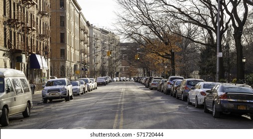 Harlem Street With Apartment Buildings And Parked Cars