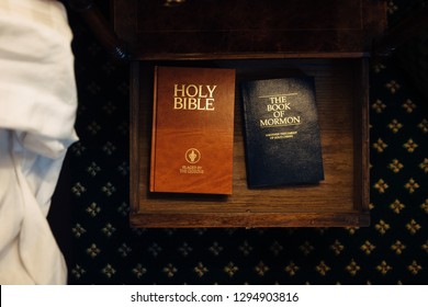 Harlow, UK - November 23, 2018: Gideon’s Holy Bible Placed Next To The Book Of Mormon In A Hotel Room Drawer