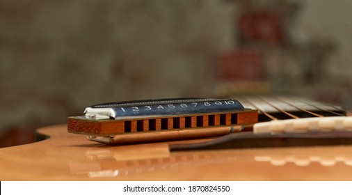 Harmonica Blues Harp - blues diatonic harp for playing country and Western.On light background.