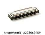 Harmonica, also French harp, blues harp, and mouth organ, isolated on white background with clipping path included. Free reed wind instrument used worldwide in blues, American folk, jazz, rock and rol