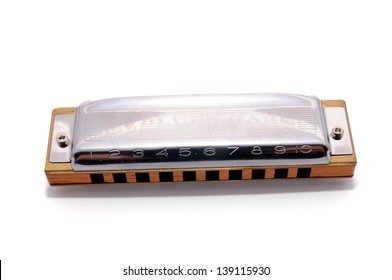 Harmonica, also French harp, blues harp, and mouth organ, isolated on white background. Is a free reed wind instrument used worldwide in blues, American folk  music, jazz, country, and rock and roll.