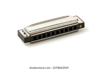 Harmonica, also French harp, blues harp, and mouth organ, isolated on white background with clipping path included. Free reed wind instrument used worldwide in blues, American folk, jazz, rock and rol